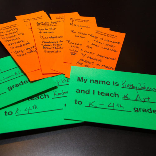 A pile of bright orange and green response cards